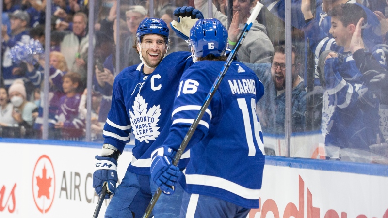 Toronto Maple Leafs' John Tavares (91) celebrates with teammate Mitchell Marner after scoring the team's third goal and his second of the game during second period NHL hockey action against the Florida Panthers, in Toronto, Sunday, March 27, 2022. THE CANADIAN PRESS/Chris Young