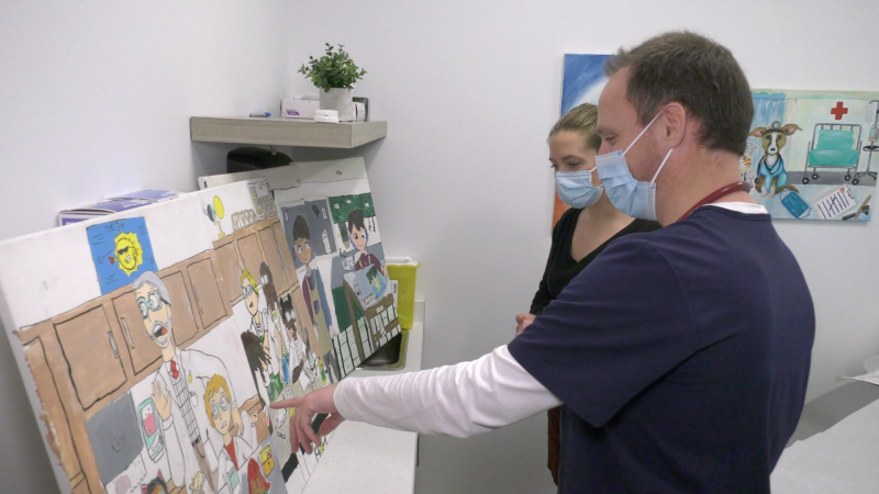 Dr. Taylor Ferrier and Kathryn Ransom-Hodges looking at submitted artwork at the Tay River Health Centre in Perth, Ont. (Nate Vandermeer/CTV News Ottawa)
