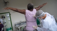 Therapist Monica Cirne gives physical therapy to COVID-19 survivor Maria dos Santos at the Movement and Life Institute in Rio de Janeiro, Brazil on Nov. 9, 2020. (AP Photo/Silvia Izquierdo)