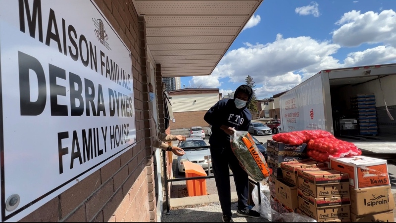 Volunteers at Debra Dynes Family House unload a much needed food delivery from the Ottawa Food Bank, as demand soars for necessities. April 5, 2022. (Tyler Fleming / CTV News Ottawa)