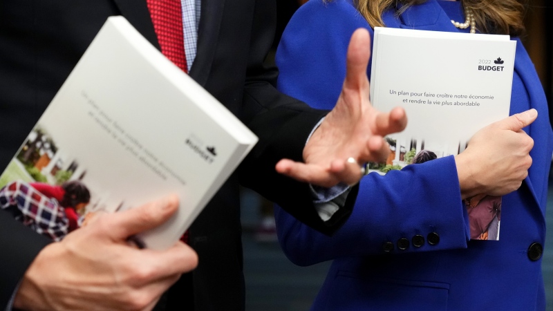 Copies of the 2022 federal budget documents are seen in the hands of Finance Minister and Deputy Prime Minister Chrystia Freeland and Prime Minister Justin Trudeau as they speak with members of the media before the release of the federal budget, on Parliament Hill, in Ottawa, Thursday, April 7, 2022. THE CANADIAN PRESS/Sean Kilpatrick
