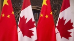 This Dec. 5, 2017, photo shows flags of Canada and China prior to a meeting of Canadian Prime Minister Justin Trudeau and Chinese President Xi Jinping at the Diaoyutai State Guesthouse in Beijing. THE CANADIAN PRESS/AP, Fred Dufour, Pool Photo