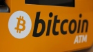 A Bitcoin logo is displayed on an ATM in Hong Kong, Thursday, Dec. 21, 2017. A cryptocurrency expert was sentenced Tuesday, April 12, 2022, to more than five years in federal prison for helping North Korea evade U.S. sanctions. (AP Photo/Kin Cheung, File)