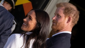 Prince Harry and Meghan Markle, Duke and Duchess of Sussex, arrive at the Invictus Games venue in The Hague, Netherlands, Friday, April 15, 2022. (AP Photo/Peter Dejong)