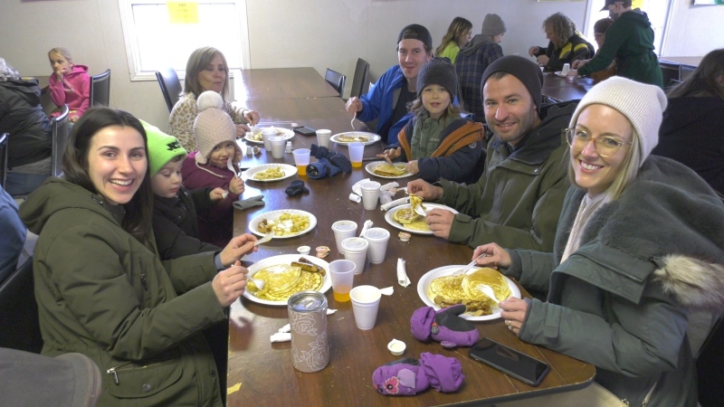 Megan Lagrois (left) enjoying pancakes with friends and family at the Maple Syrup Festival in Delta. Ont. (Nate Vandermeer/CTV News Ottawa)