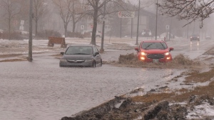 Concordia Avenue in Winnipeg is flooded on April 24, 2022, as cars attempt to cross the water. (Source: Mason DePatie/ CTV News Winnipeg)