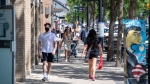 People walk in downtown in Saskatoon, Sask., Friday, June 25, 2021. (THE CANADIAN PRESS/Liam Richards)