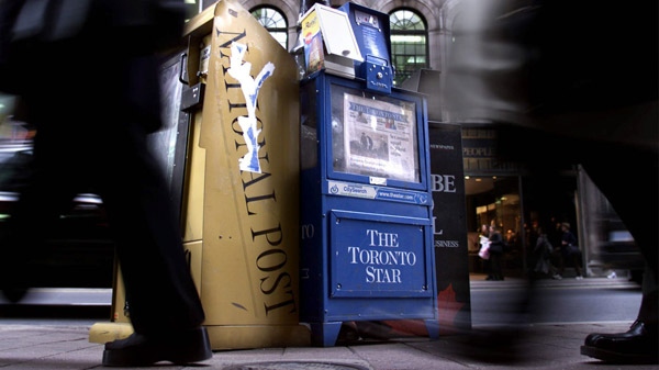 Three of Toronto's english language daily newspapers sit in boxes on a street corner in downtown Toronto, Tuesday, Oct. 26, 1999. (Kevin Frayer / THE CANADIAN PRESS)