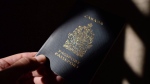 A Canadian passport is displayed in Ottawa on July 23, 2015. THE CANADIAN PRESS/Sean Kilpatrick 