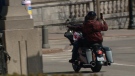 A motorcycle passenger shoots a video with their mobile phone while riding around downtown Ottawa on Friday, Apr. 29, 2022. (Aaron Reid/CTV News Ottawa)