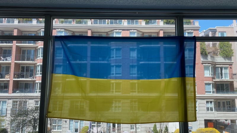 A Ukrainian flag that was once hanging in the window of Anastasia Pioro's Midtown Toronto apartment is seen in this image. (Supplied)