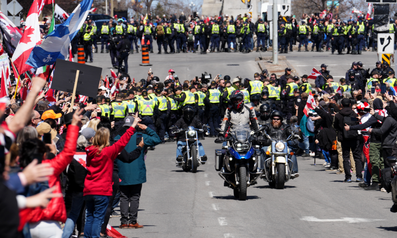 Participants cheer on protesters riding motorcycles during a demonstration, part of a convoy-style protest participants are calling "Rolling Thunder", in Ottawa, Saturday, April 30, 2022. (THE CANADIAN PRESS/Sean Kilpatrick)