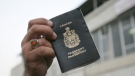 A man holds a Canadian passport in this file image.