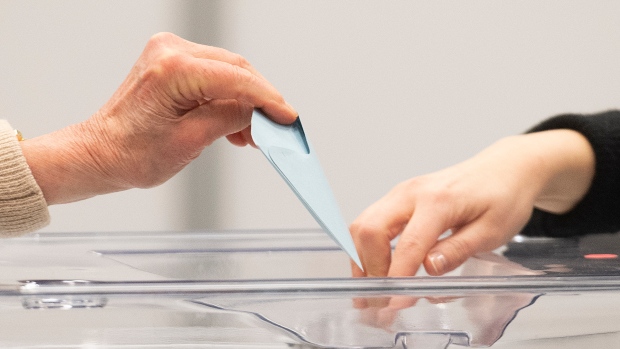 A person casts their ballot on Saturday, April 23, 2022. THE CANADIAN PRESS/Graham Hughes