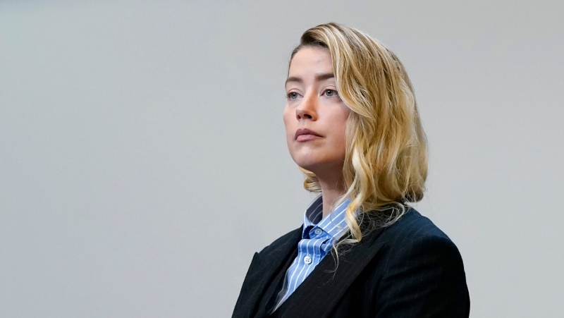 Actor Amber Heard stands in the courtroom at the Fairfax County Circuit Court in Fairfax, Va., Wednesday May 4, 2022. Actor Johnny Depp sued his ex-wife Amber Heard for libel in Fairfax County Circuit Court after she wrote an op-ed piece in The Washington Post in 2018 referring to herself as a "public figure representing domestic abuse." (Elizabeth Frantz/Pool Photo via AP)