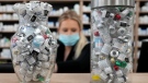 Jars full of empty COVID-19 vaccine vials are shown as a pharmacist works behind the counter at the Junction Chemist pharmacy during the COVID-19 pandemic in Toronto on Wednesday, April 6, 2022. THE CANADIAN PRESS/Nathan Denette
