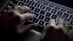 A woman uses her computer keyboard in North Vancouver, B.C., on Dec. 19, 2012. THE CANADIAN PRESS/Jonathan Hayward