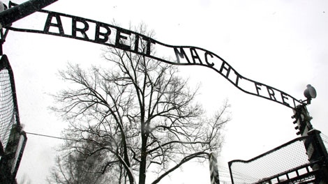 In a Jan. 26, 2005 photo visitors walk uhder the sign at the entrance gate of the Auschwitz Nazi concentration camp in Oswiecim, southern Poland. Polish police Friday Dec. 18, 2009 say the infamous iron sign over the gate to the Auschwitz memorial site with the cynical phrase "Arbeit Macht Frei" -- German for "Work Sets You Free" -- has been stolen. (AP Photo/Herbert Knosowski)