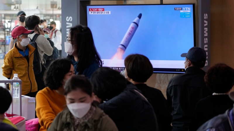 People watch a TV showing a file image of North Korea's missile launch during a news program at the Seoul Railway Station in Seoul, South Korea on May 7, 2022. (AP Photo/Ahn Young-joon)