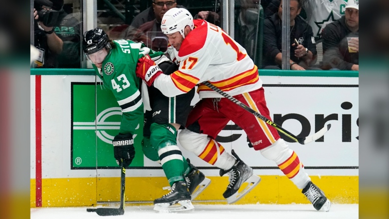 Dallas Stars left wing Marian Studenic (43) maintains control of the puck against pressure from Calgary Flames left wing Milan Lucic (17) during the second period of Game 3 of an NHL hockey Stanley Cup first-round playoff series Saturday, May 7, 2022, in Dallas. AP Photo/Tony Gutierrez
