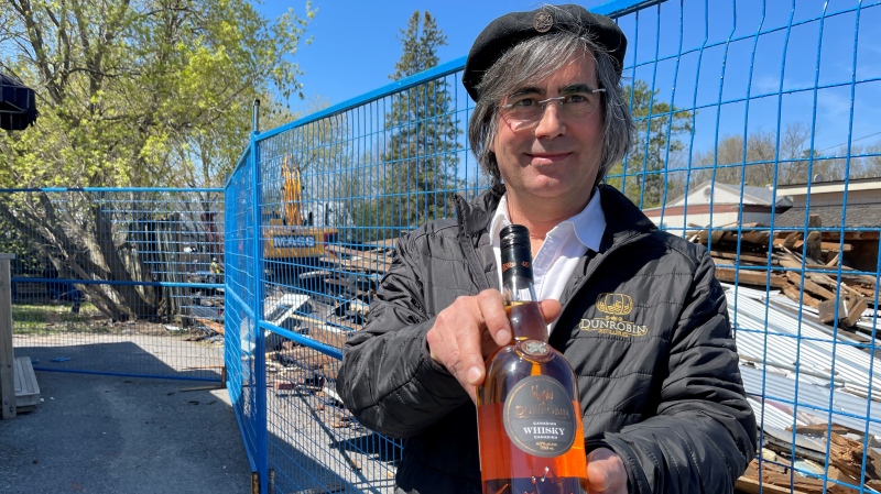 Mark Watson shows off a bottle of Dunrobin Distilleries whisky. He says the new Stittsville location will produce a variety of spirits and be a 'destination' attraction. (Peter Szperling/CTV News Ottawa)