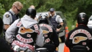 An RCMP officer stops Alberta members of the Hell's Angels motorcycle gang at a roadblock after they left the White Rock chapter's property in Langley, B.C., on July 26, 2008. (THE CANADIAN PRESS/Darryl Dyck)