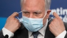 Quebec interim health director Dr. Luc Boileau removes his mask as he arrives to give a COVID-19 update, Thursday, April 21, 2022 in Montreal. The Quebec health department is recommending the extension of the mask mandate until the middle of May. THE CANADIAN PRESS/Ryan Remiorz