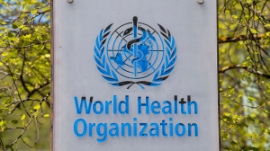FILE - The logo and building of the World Health Organization (WHO) headquarters in Geneva, Switzerland, 15 April 2020. (Martial Trezzini/Keystone via AP, file)
