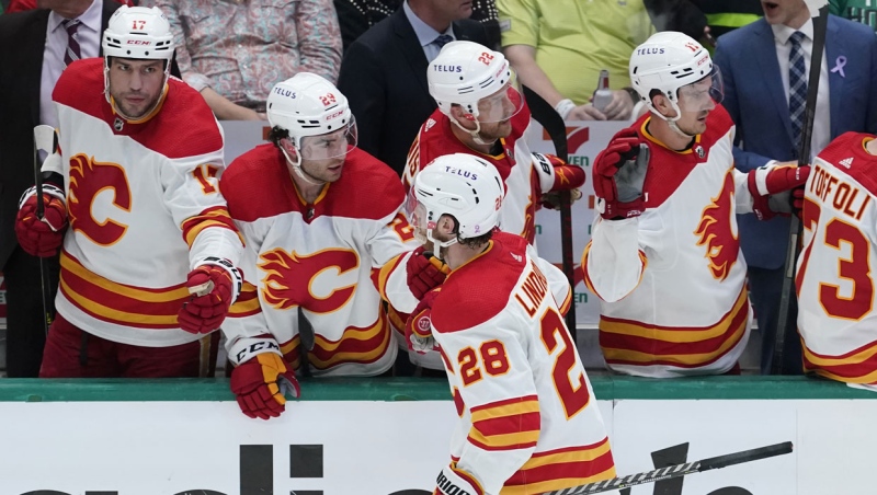 Calgary Flames center Elias Lindholm (28) celebrates with teammates after his goal in the third period of Game 4 of an NHL hockey Stanley Cup first-round playoff series, Monday, May 9, 2022, in Dallas. (AP Photo/Tony Gutierrez)