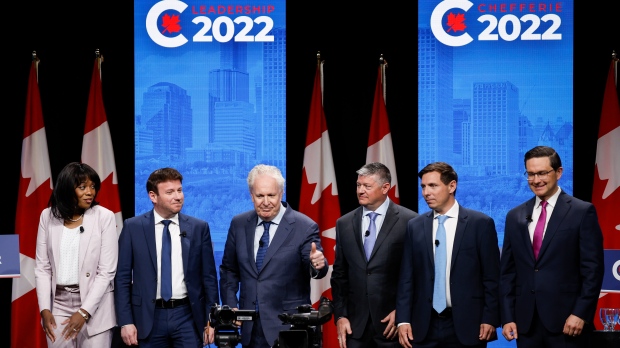 Candidates, left to right, Leslyn Lewis, Roman Baber, Jean Charest, Scott Aitchison, Patrick Brown, and Pierre Poilievre pose on stage following the Conservative Party of Canada English leadership debate in Edmonton, Alta., Wednesday, May 11, 2022.THE CANADIAN PRESS/Jeff McIntosh