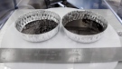 Two separate 2 inch foil pans hold lunar dirt, from the last shovel full collected by Neil Armstrong on the Apollo 11, in the lunar lab at the NASA Johnson Space Center on June 17, 2019. (Michael Wyke / AP)