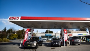 FILE - Motorists fuel up vehicles at an Esso gas station in Vancouver, on Tuesday, March 8, 2022. THE CANADIAN PRESS/Darryl Dyck