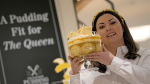 Jemma Melvin, the Platinum Jubilee Pudding winner, poses with her creation at a department store in London, Friday, May 13, 2022. (AP Photo / Alastair Grant)