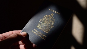 FILE - A Canadian passport is displayed in Ottawa on Thursday, July 23, 2015. THE CANADIAN PRESS/Sean Kilpatrick