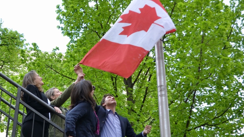 Deputy Prime Minister Chrystia Freeland, Foreign Affairs Minister Melanie Joly, Canada's ambassador to Ukraine Larisa Galadza and Prime Minister Justin Trudeau raise the flag over the Canadian embassy in Kyiv, Ukraine on Sunday May 8, 2022. THE CANADIAN PRESS/CBC News/Pool/Murray Brewster