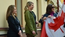 Deputy Prime Minister Chrystia Freeland, Foreign Affairs Minister Melanie Joly and Canada's ambassador to Ukraine Larisa Galadza (left to right) look on as they prepare to raise the flag over the Canadian embassy in Kyiv, Ukraine on Sunday, May 8, 2022. THE CANADIAN PRESS/CBC News/Pool/Murray Brewster