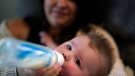 Ashley Maddox feeds her 5-month-old son, Cole, with formula she bought through a Facebook group of mothers in need Thursday, May 12, 2022, in Imperial Beach, Calif. (AP Photo/Gregory Bull)