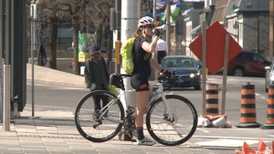 A cyclist stops to take a drink amid record-breaking heat in Ottawa. May 13, 2022. (CTV News Ottawa)