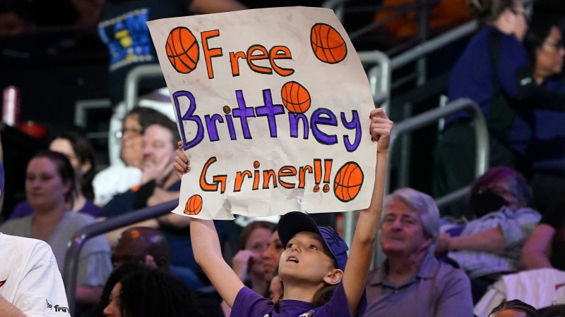 A young Phoenix Mercury fan holds up a sign "Free Brittney Griner" during a WNBA basketball game against the Las Vegas Aces, Friday, May 6, 2022, in Phoenix. (AP Photo/Darryl Webb)