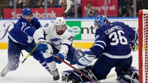 Tampa Bay Lightning left wing Nicholas Paul (20) falls towards Toronto Maple Leafs goaltender Jack Campbell (36) as Maple Leafs centre Colin Blackwell (11) defends during third period NHL first-round playoff series action in Toronto on Saturday, May 14, 2022. (The Canadian Press)