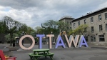 A cloudy sky over the Ottawa sign on York Street in the ByWard Market. May 15, 2022. (CTV News Ottawa)