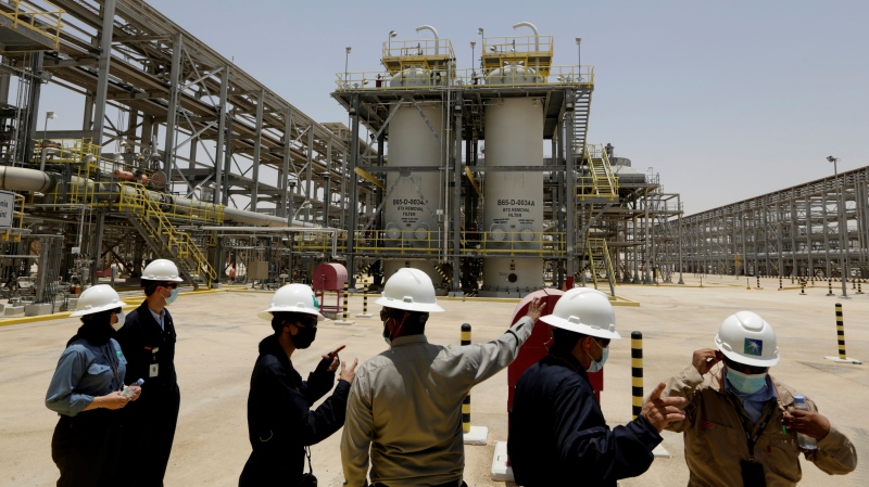 In this June 28, 2021, file photo, Saudi Aramco engineers and journalists look at the Hawiyah Natural Gas Liquids Recovery Plant, which is designed to process four billion standard cubic feet per day of sweet gas, a natural gas that does not contain significant amounts of hydrogen sulfide, in Hawiyah, in the Eastern Province of Saudi Arabia. (AP Photo/Amr Nabil, File)
