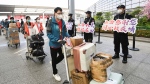 In this photo released by China's Xinhua News Agency, members of a COVID-19 testing team are greeted at an airport in Shanghai, China, as they prepare to return home to Hubei Province on May 14, 2022. (Li He/Xinhua via AP)