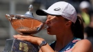 Poland's Iga Swiatek kisses the trophy after winning the final match against Turkey's Ons Jabeur at the Italian Open tennis tournament, in Rome, May 15, 2022. (AP Photo/Alessandra Tarantino)