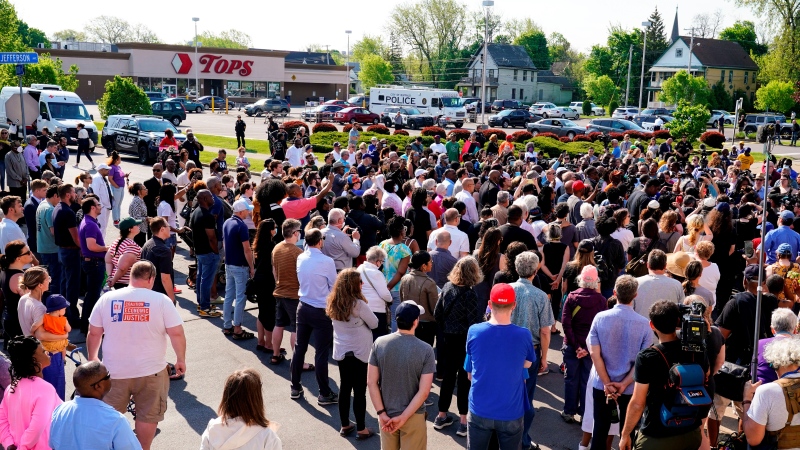 People gather outside the scene of a shooting at a supermarket in Buffalo, N.Y. on May 15, 2022. (AP Photo/Matt Rourke)