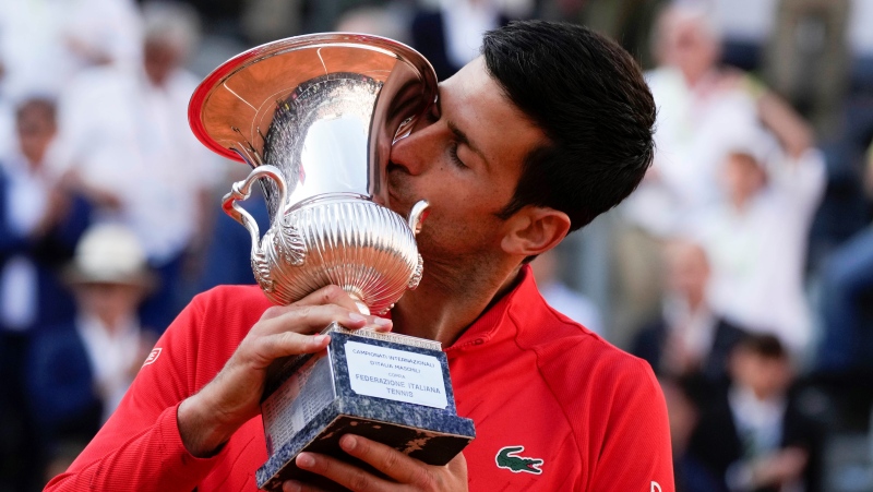 Serbia's Novak Djokovic kisses the trophy after winning the final match against Greece's Stefanos Tsitsipas at the Italian Open tennis tournament, in Rome, May 15, 2022. (AP Photo/Alessandra Tarantino)
