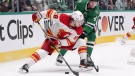 Calgary Flames left wing Andrew Mangiapane (88) skates with the puck against Dallas Stars defenseman Miro Heiskanen (4) during the second period of Game 6 of an NHL hockey Stanley Cup first-round playoff series, Friday, May 13, 2022, in Dallas. (AP Photo/Tony Gutierrez)