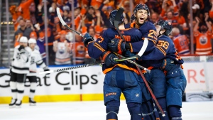 Edmonton Oilers centre Connor McDavid, left, celebrates his goal with teammates centre Leon Draisaitl, centre, and right wing Kailer Yamamoto during third period NHL playoff hockey action against the Los Angeles Kings in Edmonton, Saturday, May 14, 2022 (The Canadian Press/Jeff McIntosh).