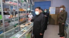 In this photo provided by the North Korean government, North Korean leader Kim Jong Un, centre, visits a pharmacy in Pyongyang, North Korea Sunday, May 15, 2022. The content of this image is as provided and cannot be independently verified. (Korean Central News Agency/Korea News Service via AP)