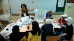 A Lebanese election worker counting votes in Beirut, Lebanon, on May 15, 2022. (Hussein Malla / AP) 